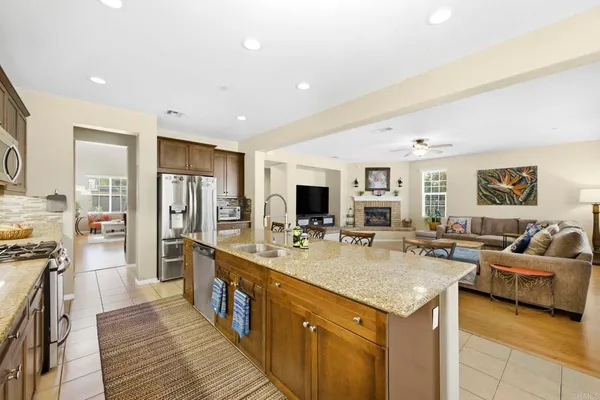 a kitchen with granite countertop stove top oven and cabinets