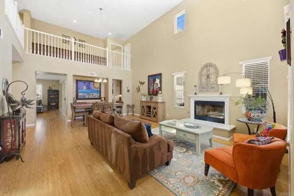 a living room with furniture a fireplace and a flat screen tv