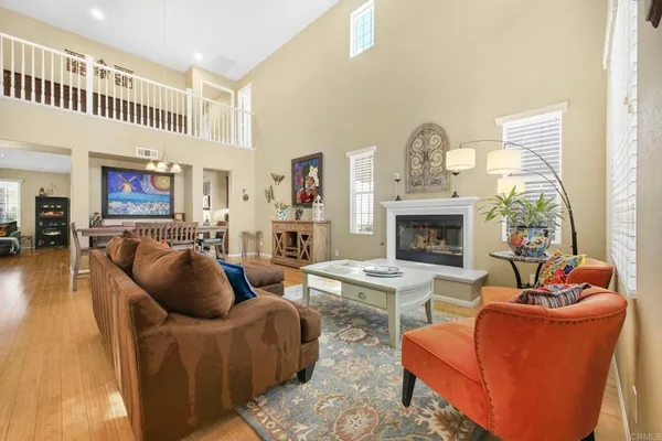 a living room with furniture a fireplace and a large window