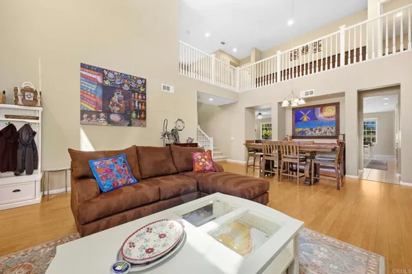 a living room with furniture and kitchen view