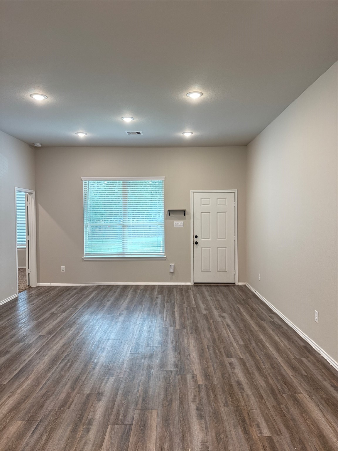 20130 Parkway Lane Montgomery, TX 77356 - Photo 17 of 18 an empty room with wooden floor and window