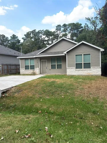 a view of a house with yard and sitting area
