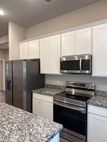 a kitchen with a stove microwave and refrigerator