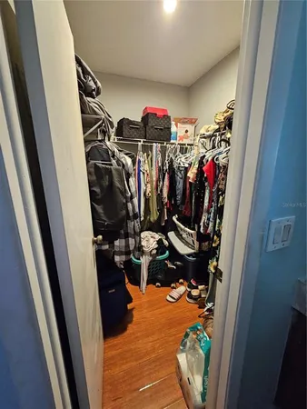a view of walk in closet with clothes