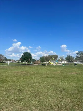 a green field with lots of trees