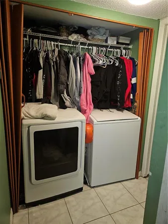 a view of walk in closet with clothes