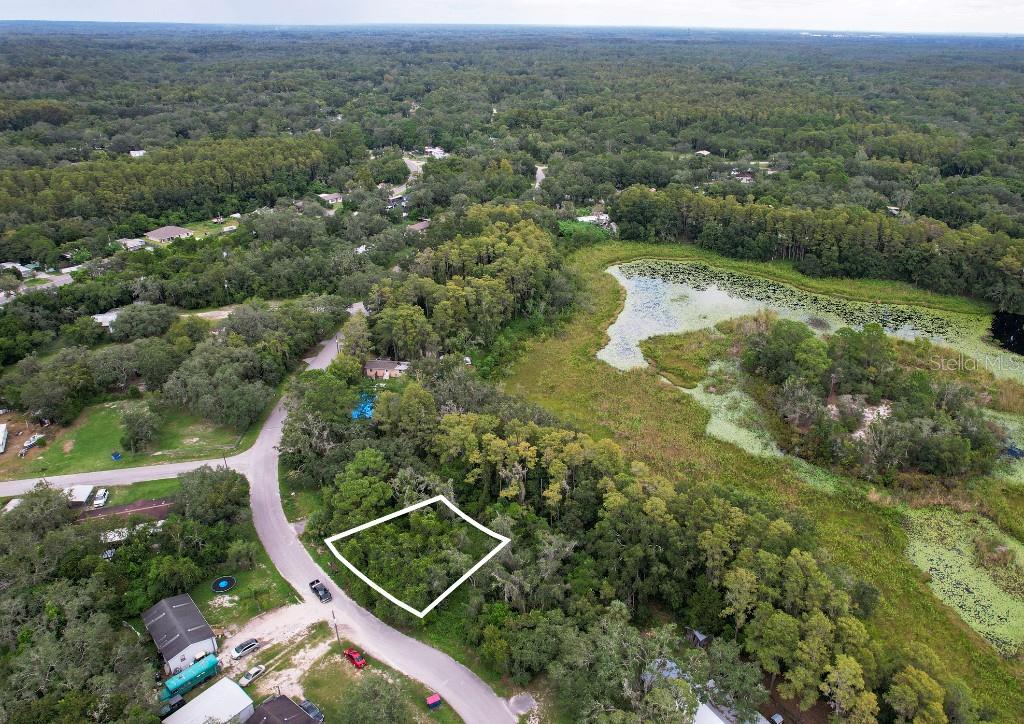 33 Poplar Street New Port Richey, FL 34654 - Photo 2 of 11 an aerial view of residential houses with outdoor space and trees