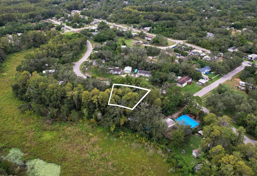 33 Poplar Street New Port Richey, FL 34654 - Photo 4 of 11 an aerial view of a house with a yard and street