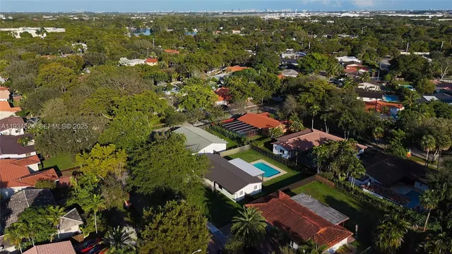 an aerial view of residential houses with outdoor space and river