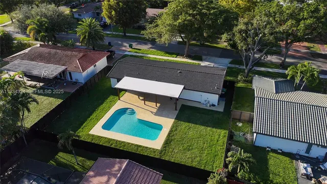an aerial view of a house with garden space and street view