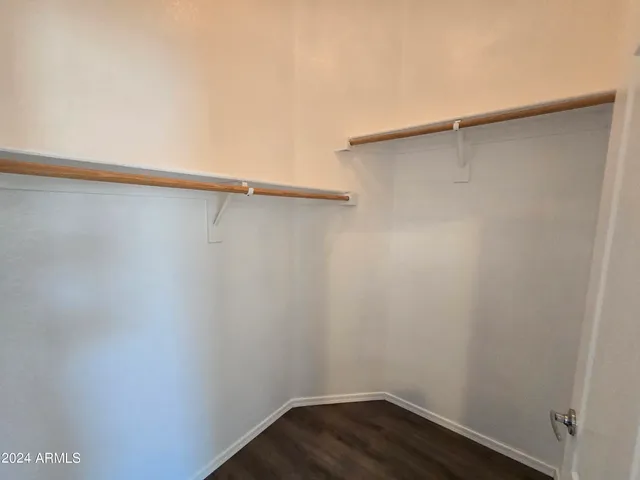 a small space with wooden floor and a window