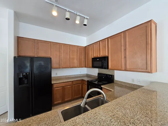 a kitchen with a refrigerator and a sink