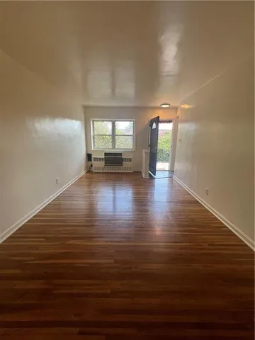 a view of an empty room with a window