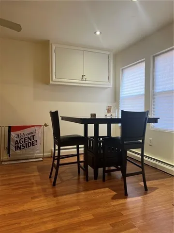 a view of a dining room with furniture wooden floor and a rug