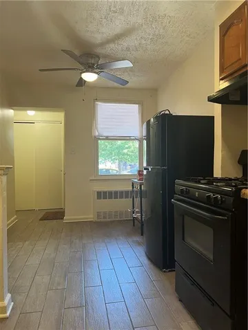 a kitchen with granite countertop a refrigerator and a stove