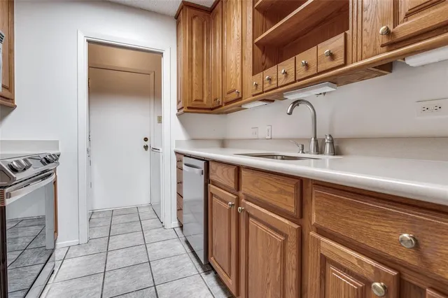a kitchen with stainless steel appliances granite countertop a sink and cabinets