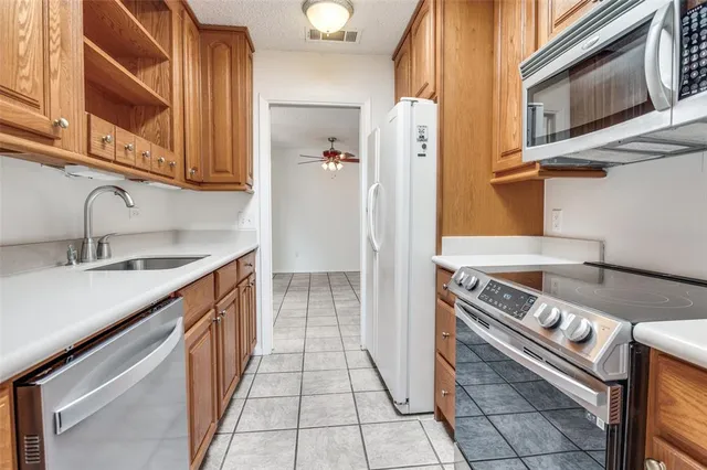a kitchen with a sink stove and cabinets