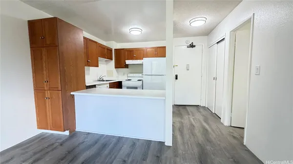 a view of kitchen with wooden floor electronic appliances and windows