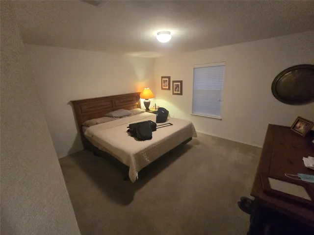 a living room with furniture and a mirror