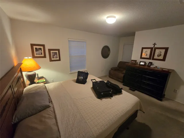 a bedroom with a bed and cabinets