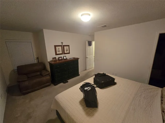 a bedroom with a bed and ceiling fan