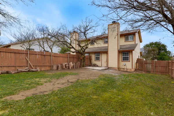 a house that has a tree in front of it