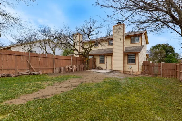 a house that has a tree in front of it