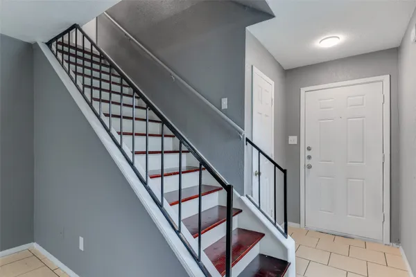 a view of staircase with wooden floor and white walls