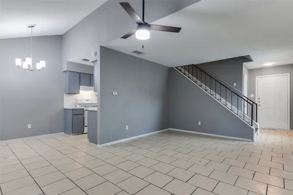 a view of a room with a ceiling fan and window