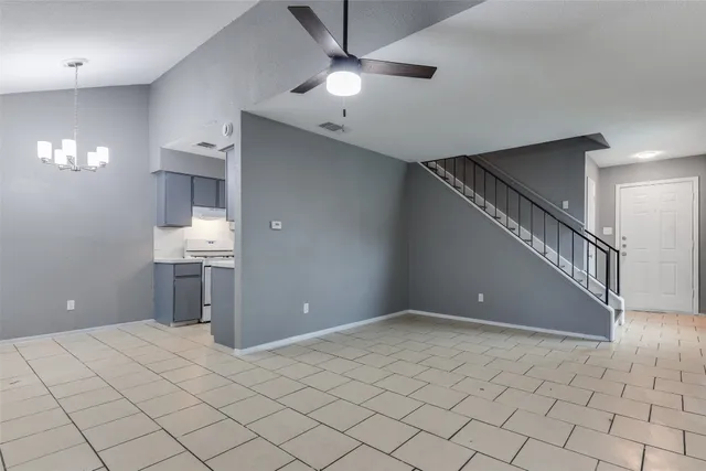 a view of a room with a ceiling fan and window