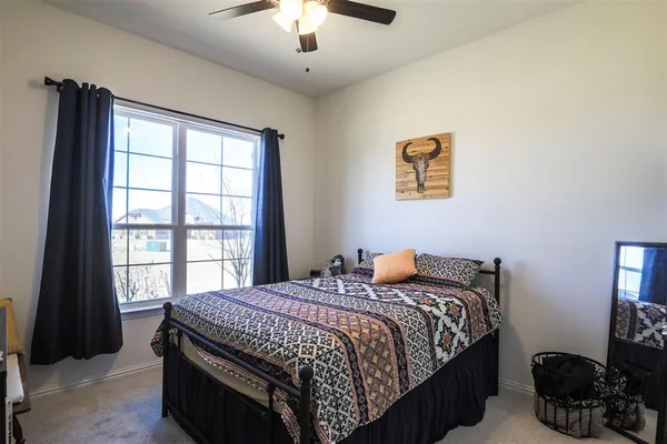 a bathroom with a sink a toilet and shower curtain