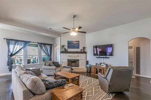 a living room with furniture a fireplace and a large window