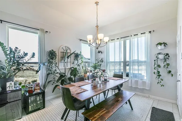 a kitchen with stainless steel appliances a table chairs and white cabinets