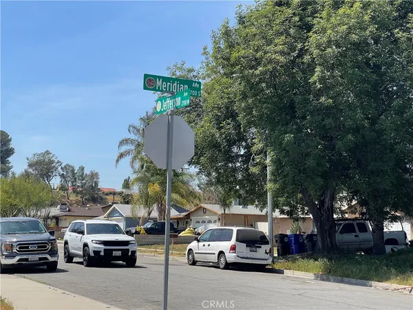a couple of cars parked in front of a house