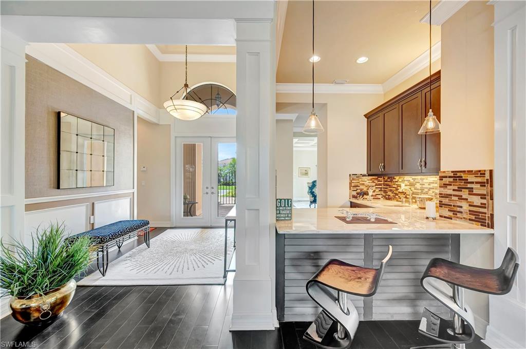 3200 Atlantic Circle Naples, FL 34119 - Photo 12 of 41 a view of a kitchen area with furniture and wooden floor