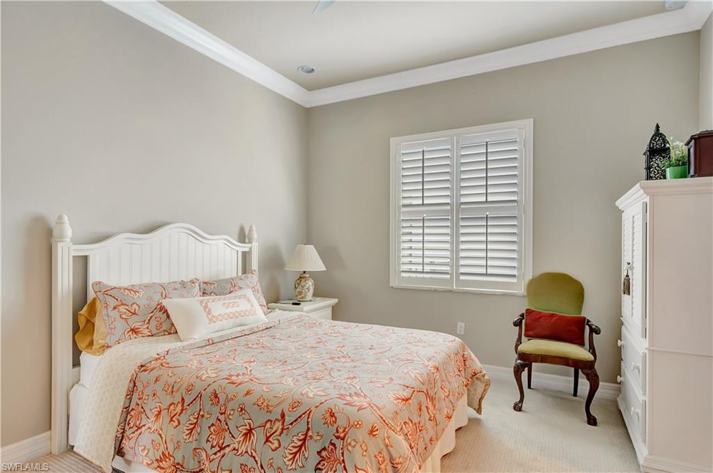 3200 Atlantic Circle Naples, FL 34119 - Photo 28 of 41 a bedroom with a bed chair and window