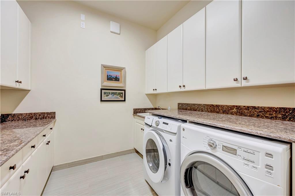 3200 Atlantic Circle Naples, FL 34119 - Photo 33 of 41 a utility room with dryer and washer