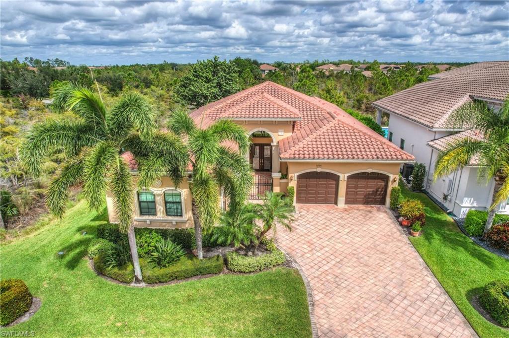3200 Atlantic Circle Naples, FL 34119 - Photo 38 of 41 a front view of a house with a yard