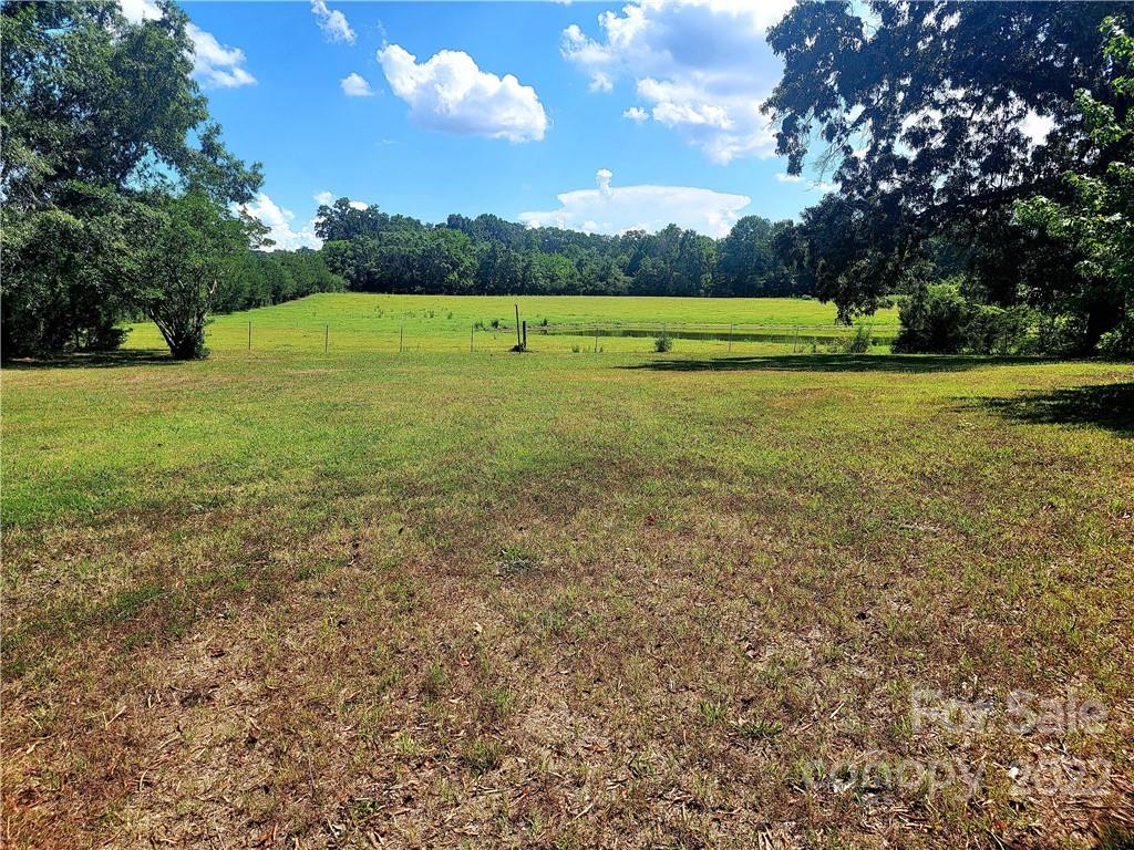 3100 Old Monroe Marshville Road Wingate, NC 28174 - Photo 8 of 15 a view of outdoor space with green field and trees