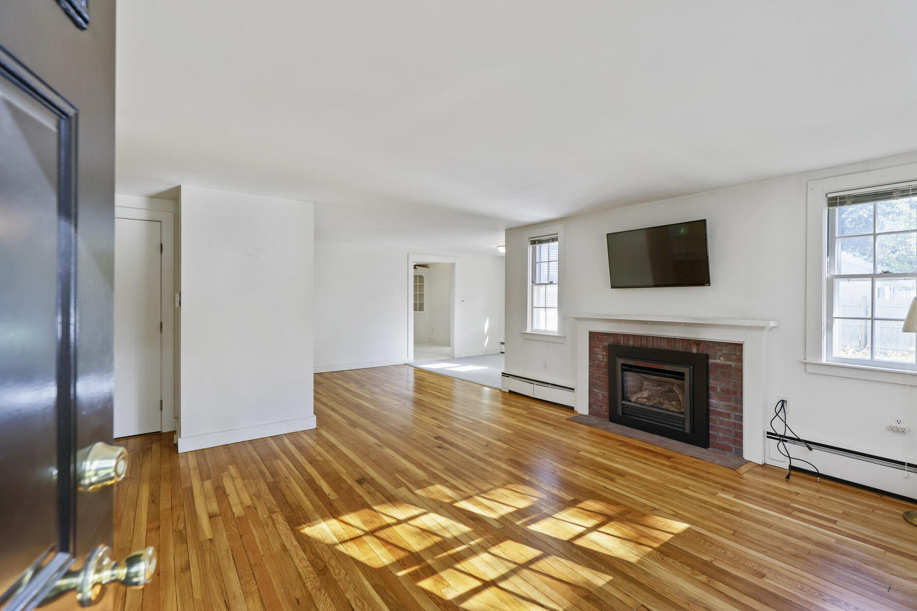 30 Davis Road Falmouth, MA 02540 - Photo 12 of 38 a view of livingroom with furniture a fireplace and wooden floor