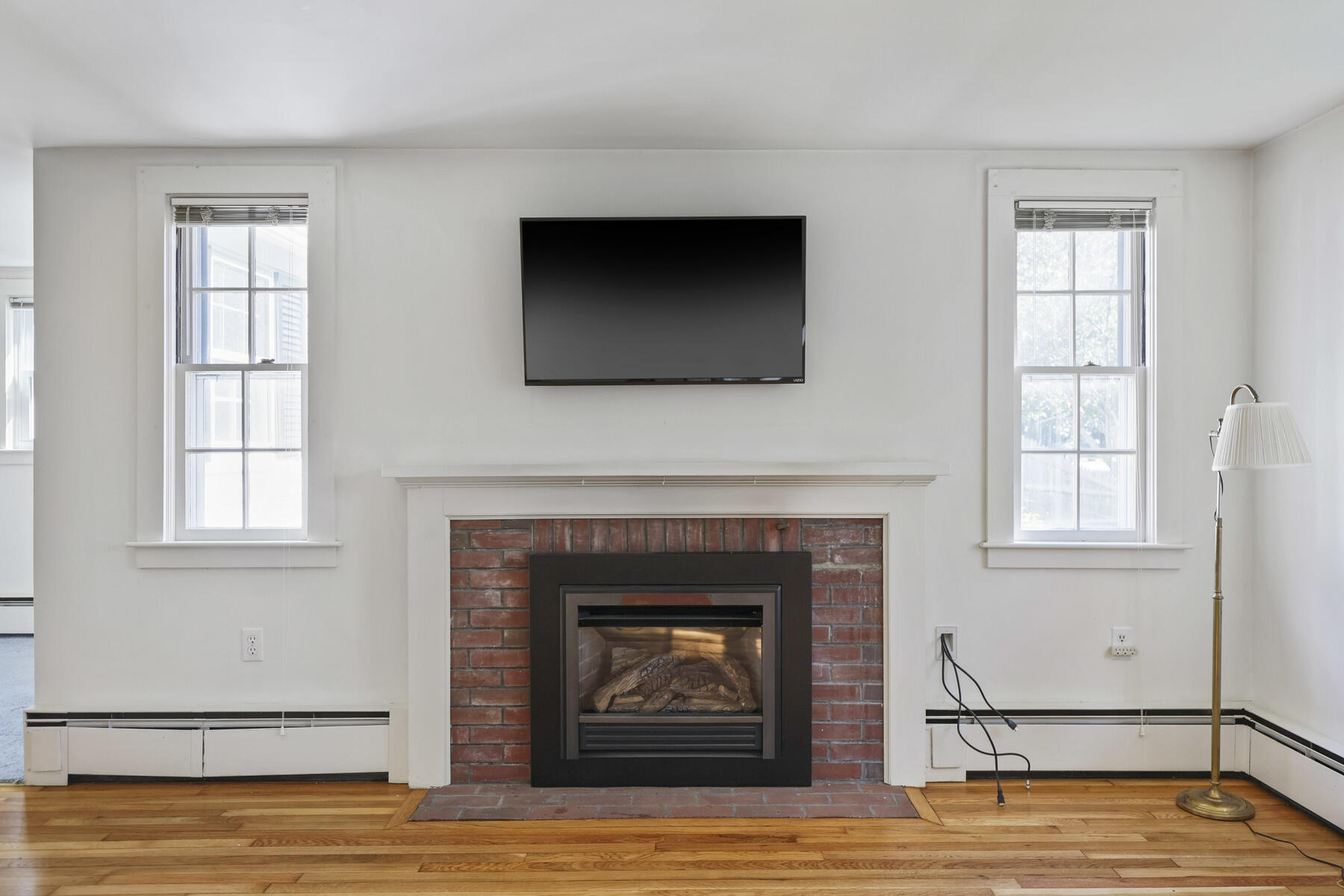 30 Davis Road Falmouth, MA 02540 - Photo 13 of 38 a living room with fireplace and a wooden floor