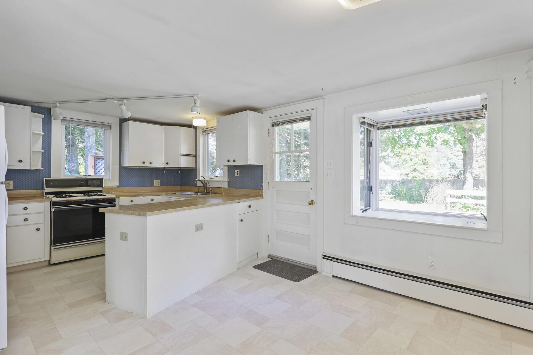 30 Davis Road Falmouth, MA 02540 - Photo 19 of 38 a kitchen with granite countertop white cabinets and white appliances