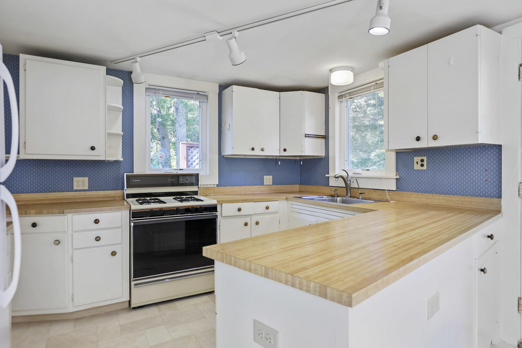 30 Davis Road Falmouth, MA 02540 - Photo 20 of 38 a kitchen with granite countertop a sink stove and cabinets