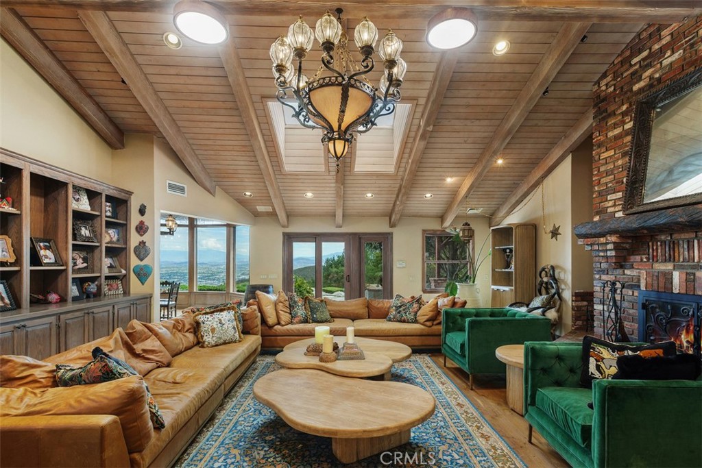 27777 Sycamore Mesa Road Temecula, CA 92590 - Photo 19 of 72 Spacious family room with wood-beam ceiling, wood burning fireplace and custom built-ins
