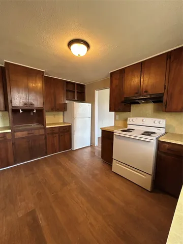 a kitchen with granite countertop cabinets stainless steel appliances and a sink