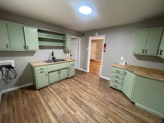 3602 Hallbrook Street Memphis, TN 38127 - Photo 11 of 12 Kitchen with green cabinets, open shelves, and light wood-style flooring