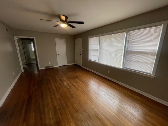 3602 Hallbrook Street Memphis, TN 38127 - Photo 2 of 12 Unfurnished bedroom featuring dark wood-style floors, a ceiling fan, and connected bathroom