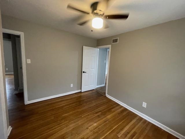 3602 Hallbrook Street Memphis, TN 38127 - Photo 4 of 12 Unfurnished room featuring dark wood finished floors and a ceiling fan
