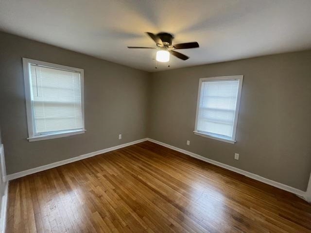 3602 Hallbrook Street Memphis, TN 38127 - Photo 6 of 12 Unfurnished room featuring dark wood finished floors and a ceiling fan