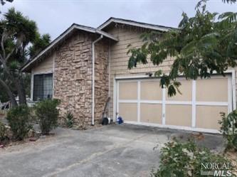 a view of a house with a yard and garage